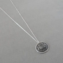 Load image into Gallery viewer, Wax seal necklace with unicorns, birds, stars, and Latin motto with promise of time. Antique wax seal charm jewelry crest made in silver.

