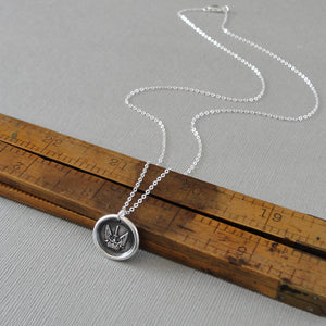 Silver wax seal necklace symbolizing protected strength and success